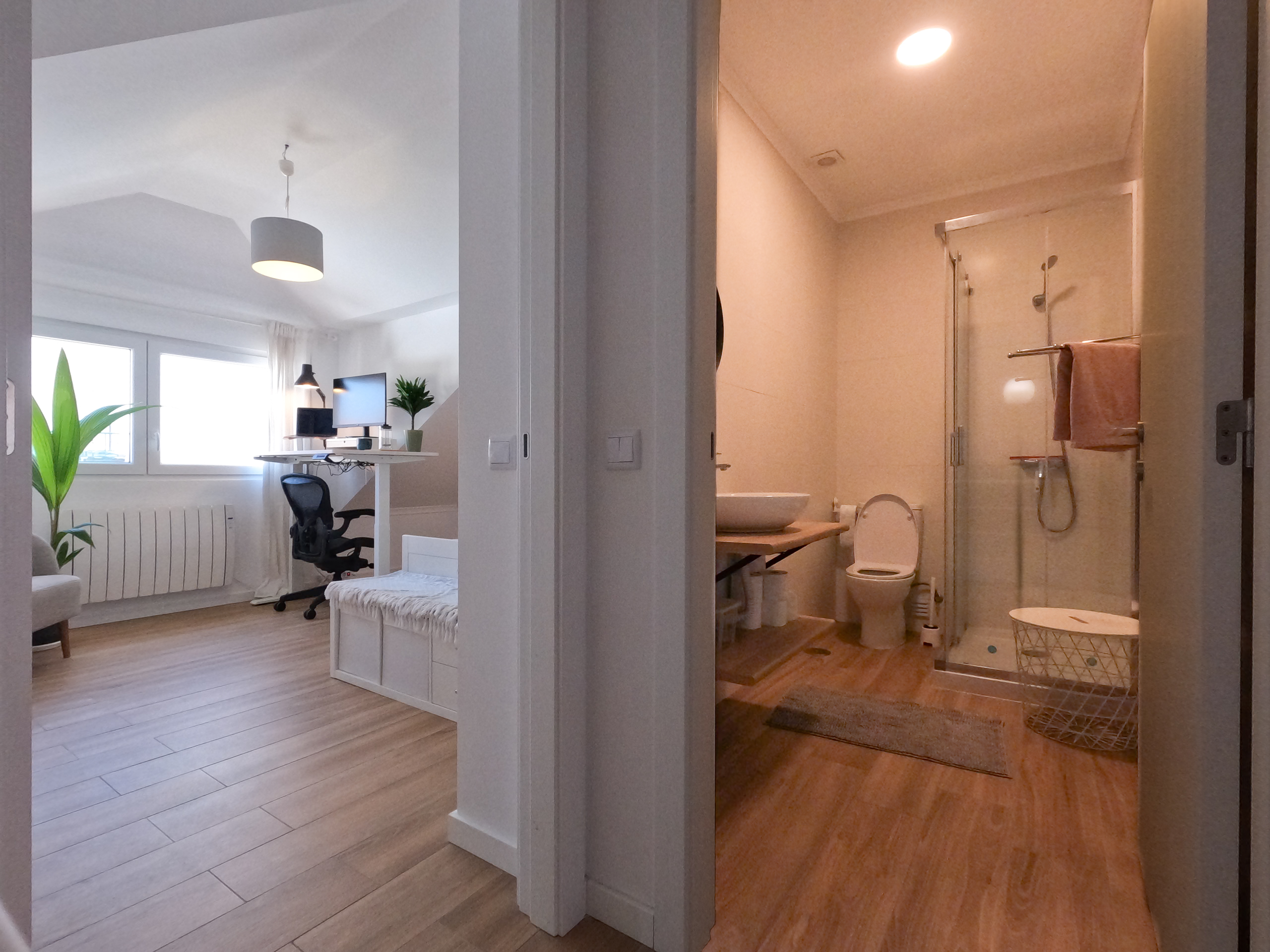 Hallway view showing bedroom and private bathroom side by side