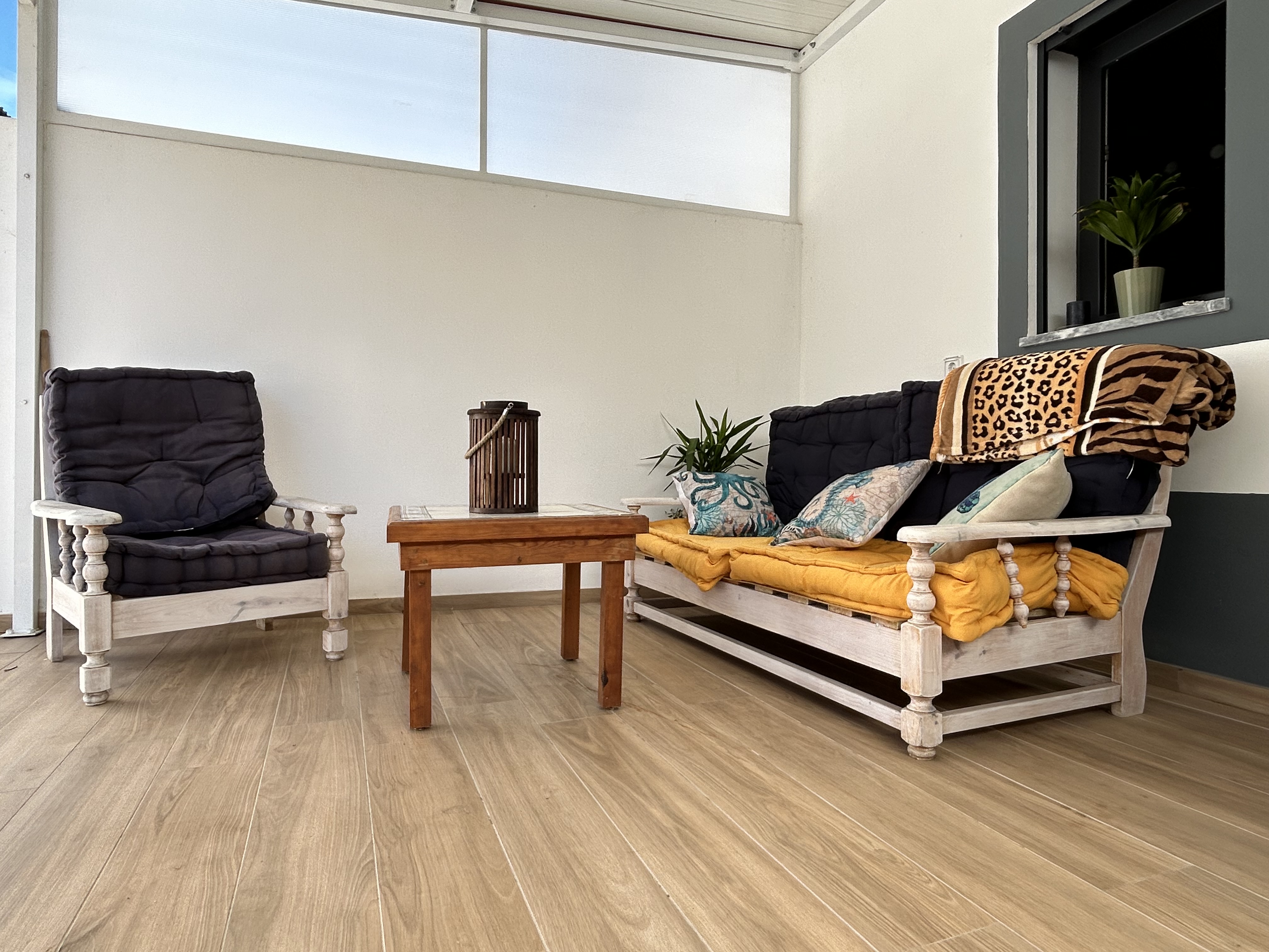 Sun terrace with outdoor lounge furniture and cushions